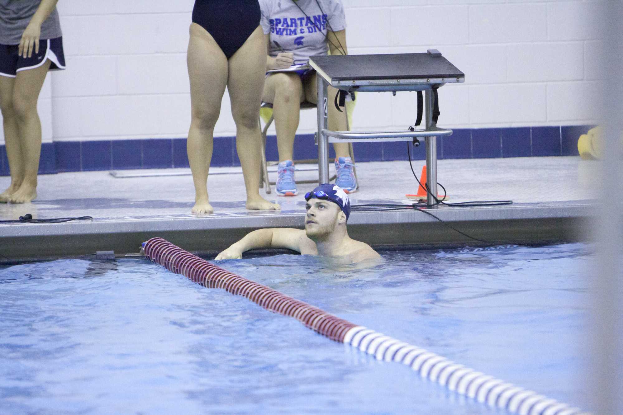 A Spartan swimmer looks up to see the race results. The results have been good as the Spartans continue to win on the road.