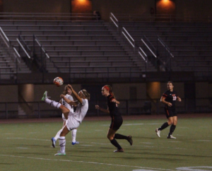 Stretching her leg high in the air, fourth-year Amy Lindberg tries to corral the ball in the middle of the pitch.  