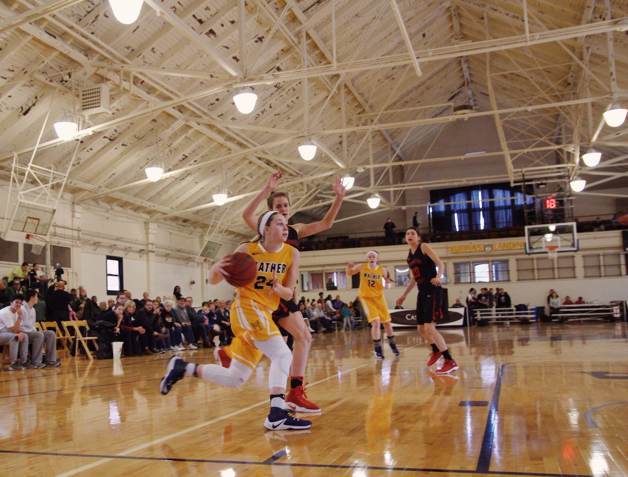 Driving down the baseline, Hillary Hellmann (24) looks to score an easy bucket against the Wash U defense.