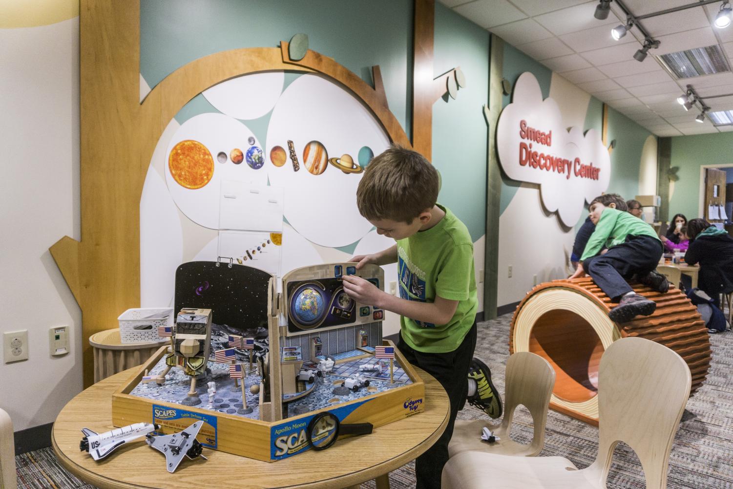 Parents and children engage in creative and educational activities centered around astronomy for the Cleveland Museum of Natural History (CMNH)'s Astronomy Day.