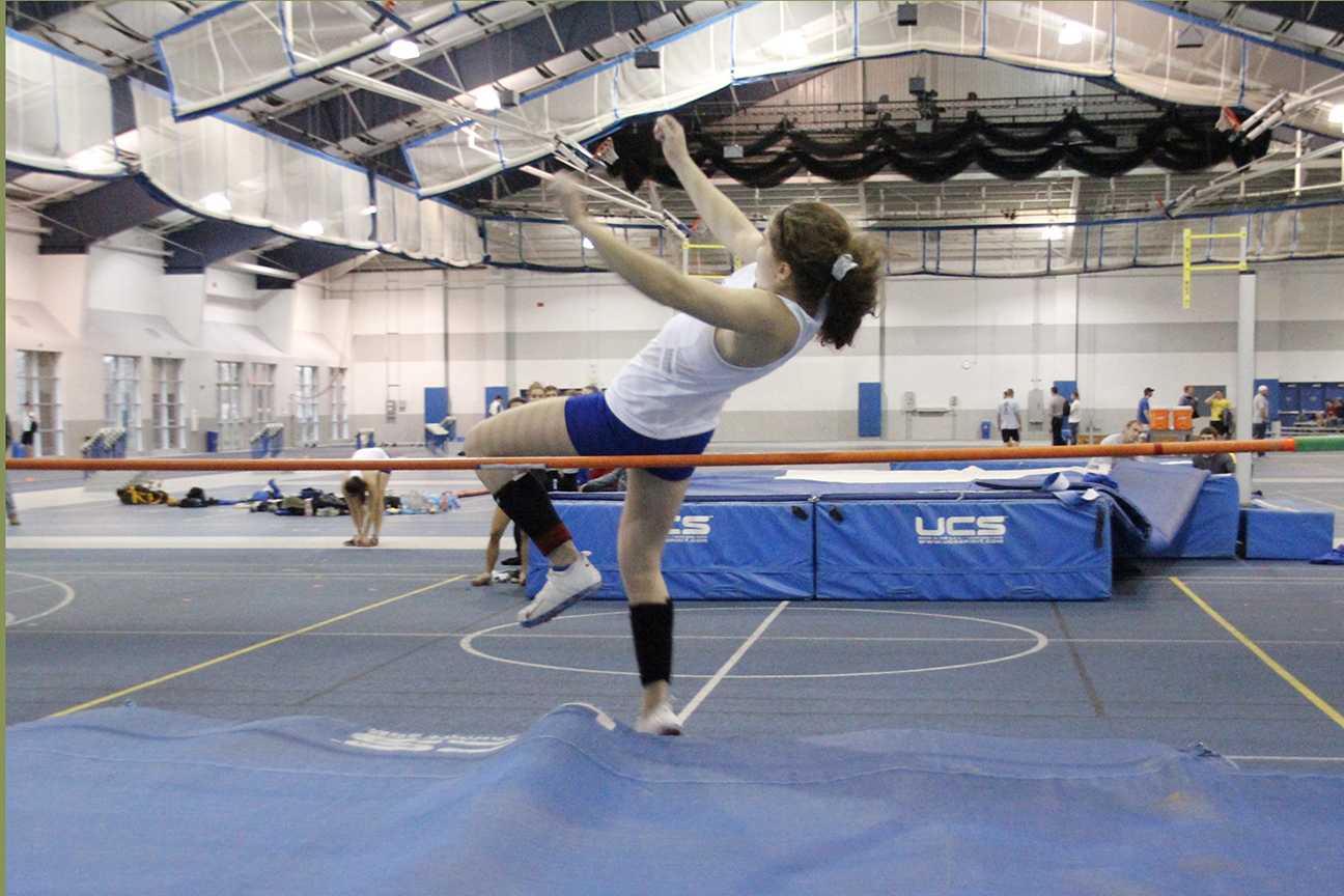 Sophomore Sophia Herzog performs the high jump. Herzog tied for the top height in the pole vault of 10.5 feet but finished second on attempts.