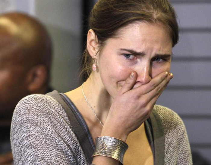 Amanda Knox reacts to returning home to the United States in 2011. Accused of killing her roommate in Italy, Knox’s was acquitted by Italy’s final court of appeal after serving four years of her 25 year sentence. Italian courts have ordered a retrial. She will be tried in absentia if she does not return to the country. 