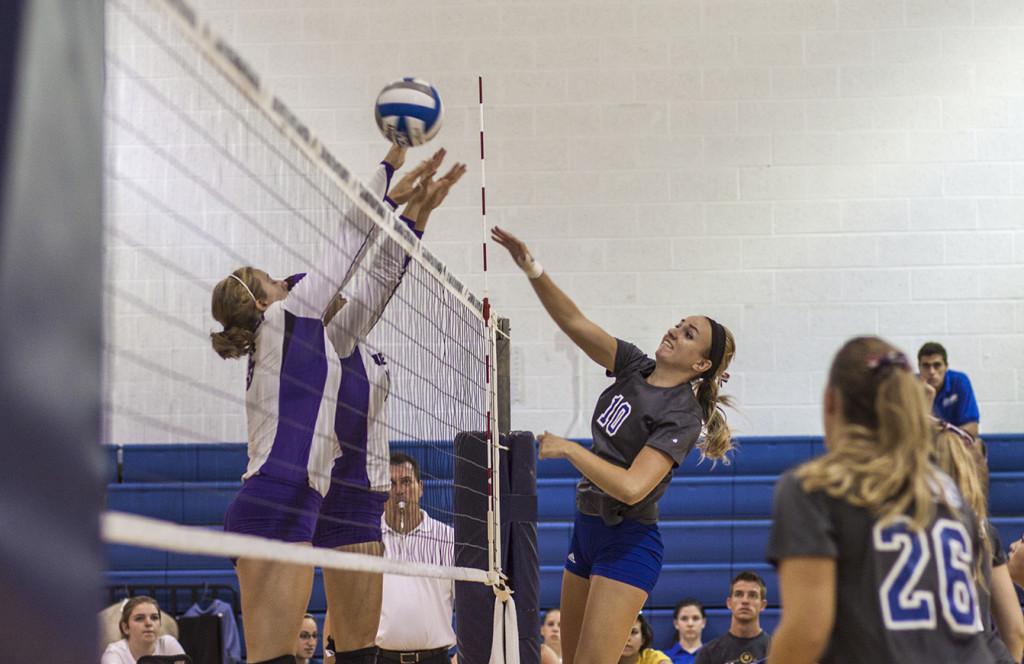 Sophomore Haley Kauffman goes up for a block as teammate Carolyn Bogart looks on during a match versus Capitol on Septermber 7th.