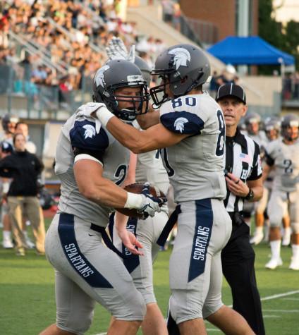 Wide recievers Luke DiFrancesco (right) and Ethan Albers celebrate their opening game victory against Carnegie Mellon University. Andrew Hodowanec/Observer