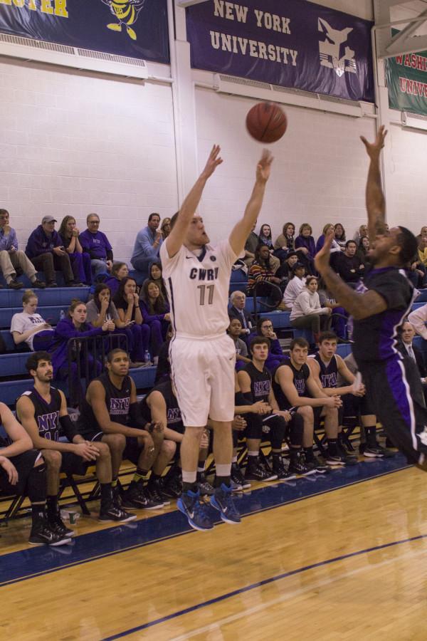 Junior Matt Clark hits a clutch three point shot against New York University.