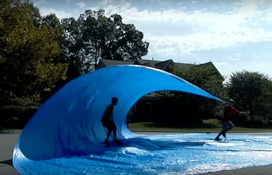 Tarp+surfing+simulates+a+wave+for+longboarders+to+roll+through.