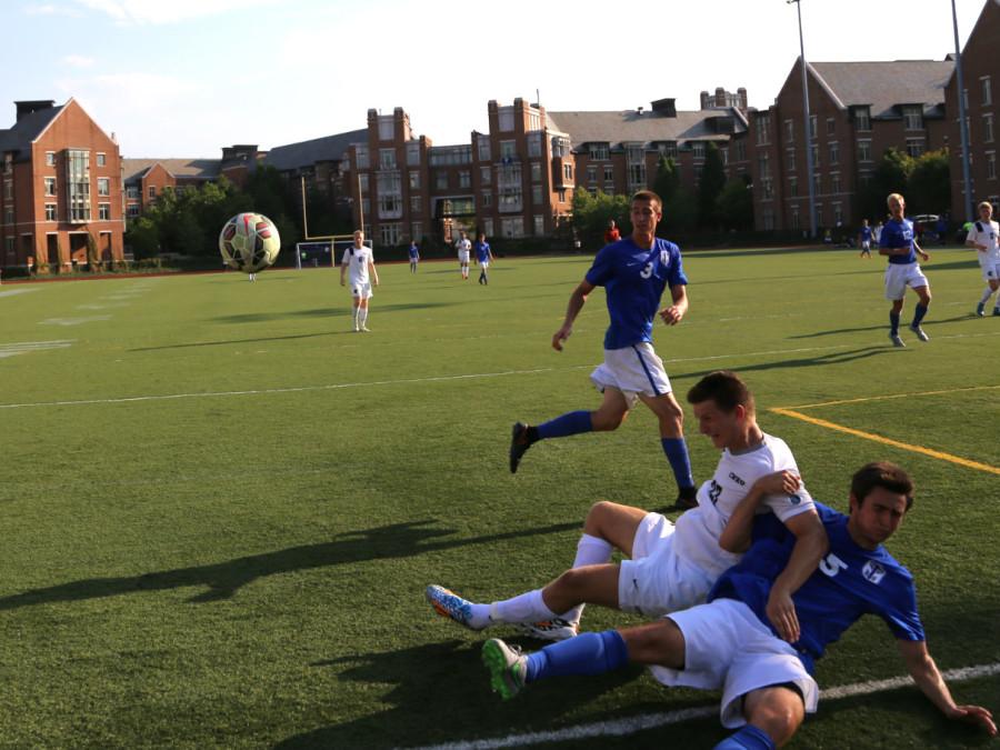 Third year student Brandon White collides with a Thomas More defender earlier this season. The Spartans won their first UAA game this weekend against NYU. 