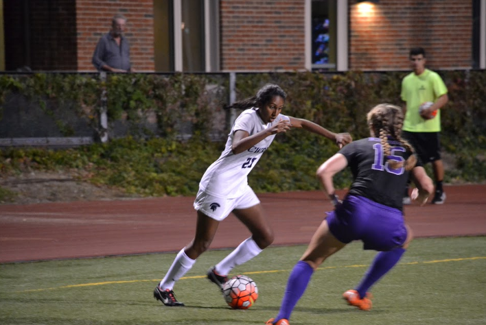Third-year defender Neha Cheemalavagu (left) uses fancy footwork to dribble around a Kenyon Lady.