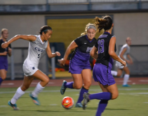 First-year forward Kimberly Chen (center) sprints past two Kenyon defenders.