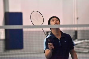 Will Chen searches for the shuttlecock as he waits to return a serve. 