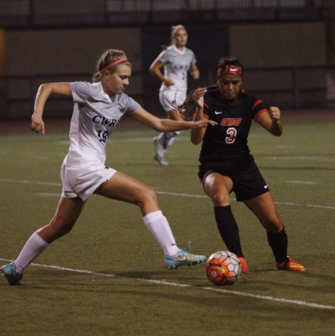 Second-year forward Maggie Tyma attempts to race past a Ohio Wesleyan defender and keep possession for the Spartans
