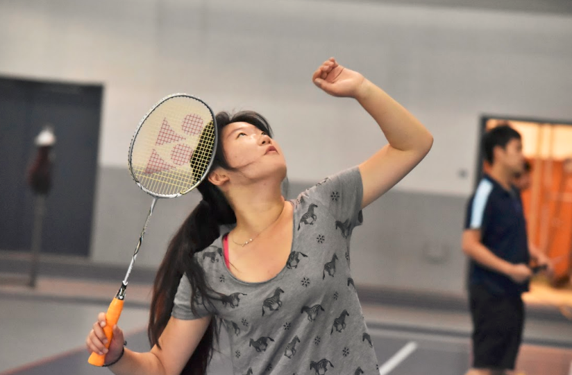 Keeping her eye on the shuttlecock, a member of the Badminton Club concentrates hard during a practice. The Club won all 11 matches in their first ever meet as an official club. 