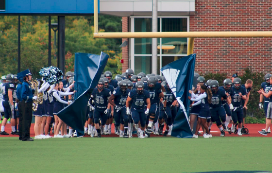 The Spartans burst onto the field before their home game versus St. Vincent College earlier in the season.
