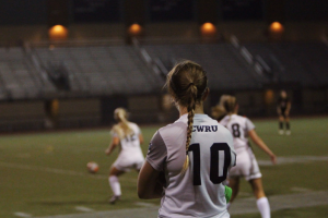 Fourth-year Anne Backlund looks on as teammates battle for possession. The women’s soccer team wrapped up their season on Nov. 5 with a 2-0 loss. 