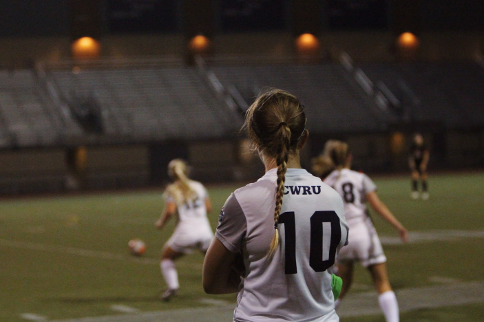 Fourth-year Anne Backlund looks on as teammates battle for possession. The women’s soccer team wrapped up their season on Nov. 5 with a 2-0 loss.  