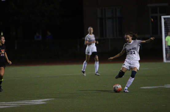 Looking to move the ball down the field, fourth-year defender Madeline Pollifrone rears back to strike the ball during a home match earlier this season.
