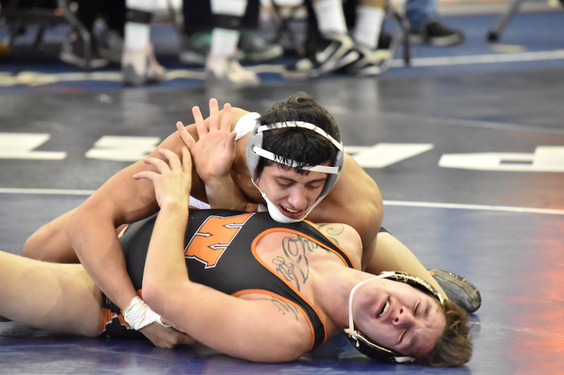 In the process of demoralizing his opponent, Mike Petersen is looking for the pin. The wrestling team travels to Wheaton College for the Pete Willson Invitational this weekend.