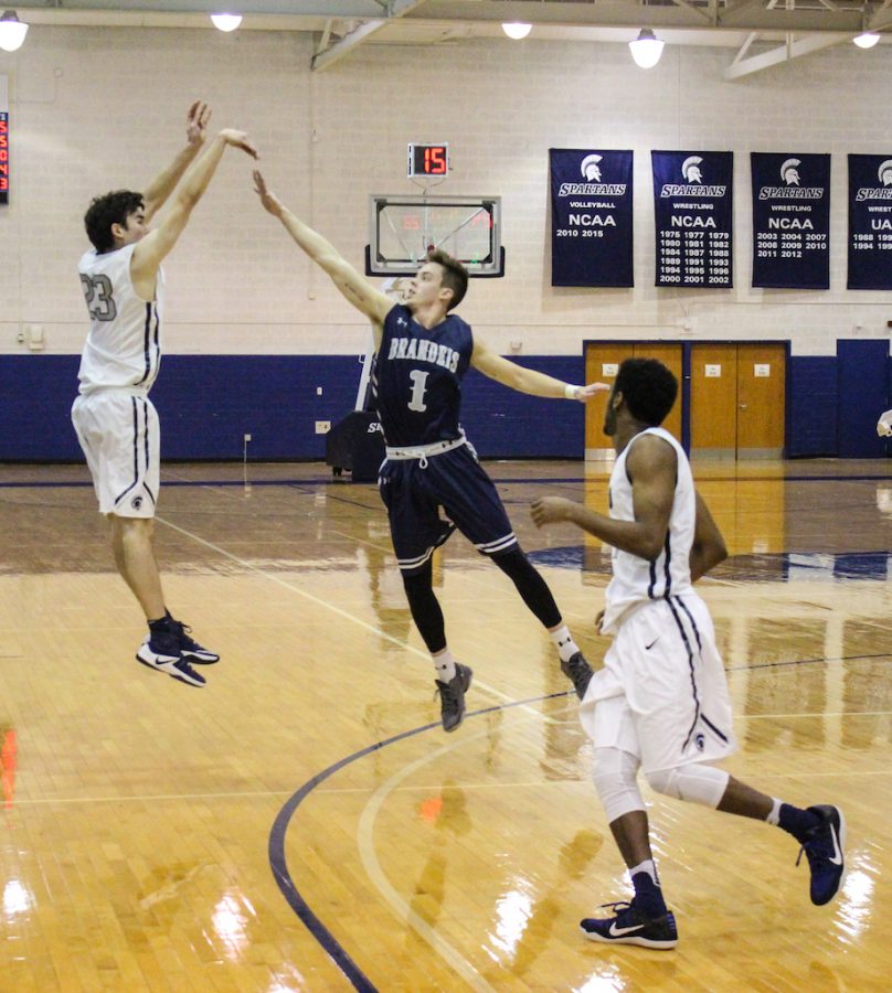 Sam Henson drains a three-pointer against Brandeis. The first-year forward was a perfect six-of-six from beyond the arc.