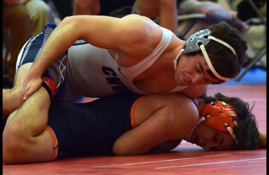 Fourth-year veteran wrestler Cito Balsells tries to pin his opponent at the RIT Invite.