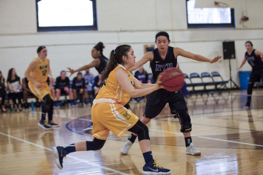 First-year guard Emily Todd passes the ball during the Spartans home game against NYU.