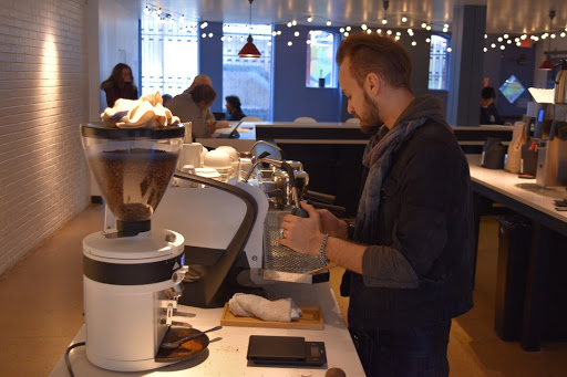 A barista behind the counter of Blue Sky Brews, which opened its doors on Feb. 7.