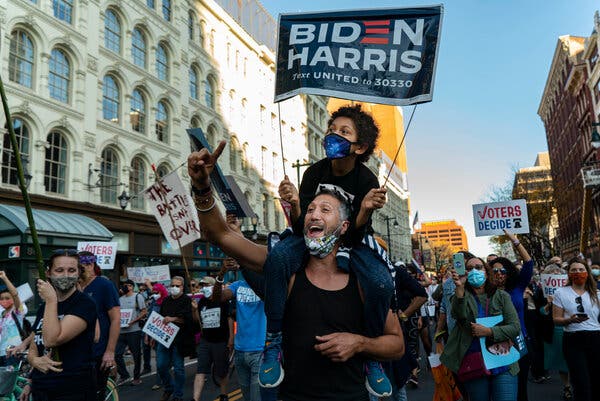 Biden voters celebrate in Times Square after Biden victory.
