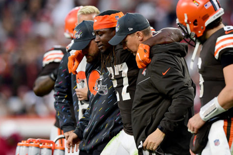 Injured Browns running back Kareem Hunt is escorted off the field, adding to the growing list of key players sidelined due to injury. 
