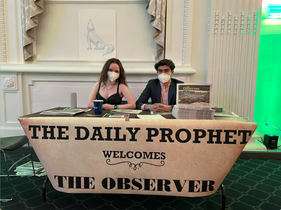 The Observer's director of print (Sara Khorshidi, left) and executive editor (Shreyas Banerjee, right) table at this year's Yule Ball, posing as the Daily Prophet from the 