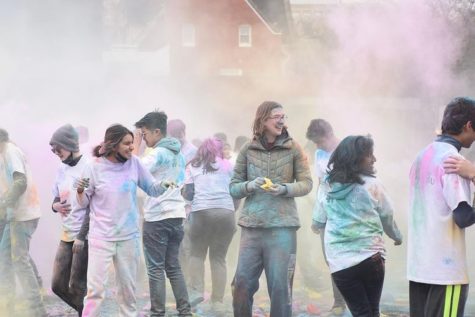 CWRU students run amongst the clouds of vibrant colors at Holi, enjoying the traditional Hindu welcome of spring. 