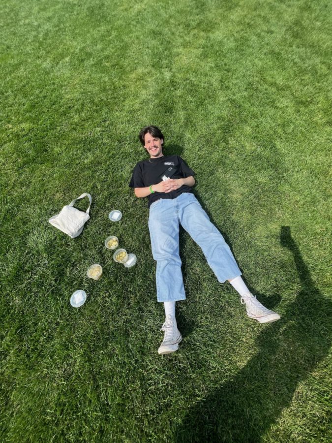 Life Editor Joey Gonzalez reclines on the verdant grass of Downtown Cleveland as he rejoices in the taste of authentic Cleveland-brewed pickles
