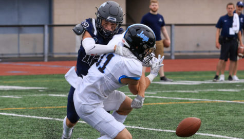 In a heated attempt to block the Blue Jays control of the football, second-year Dominic Sais (left) sacks first-year Carson Bourdo (right).