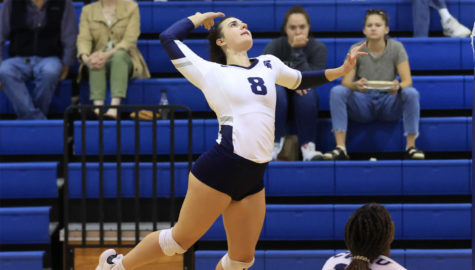 First-year outside hitter Kalli Wall serves the ball during a match against Washington University in St. Louis, helping CWRU secure an upset against the fourth-ranked school.