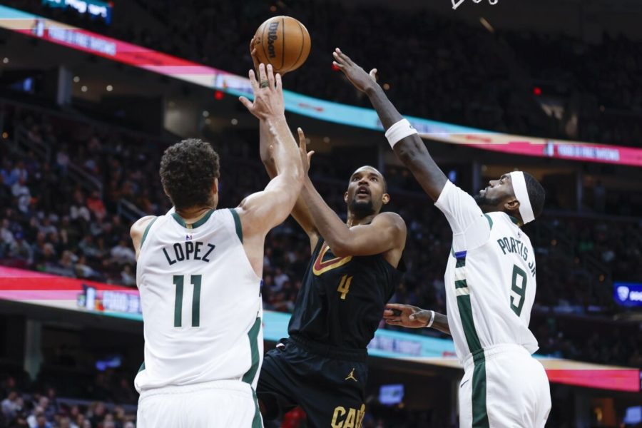Milwaukee Bucks centers Brook Lopez and Bobby Portis attempt to block Cleveland Cavaliers center Evan Mobley