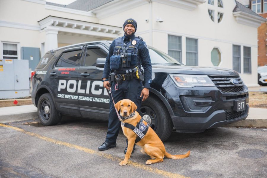 Newly sworn-in K-9 officer Spartie poses next to his handler, Officer Jimiyu Edwards of the Case Western Reserve Police Department.