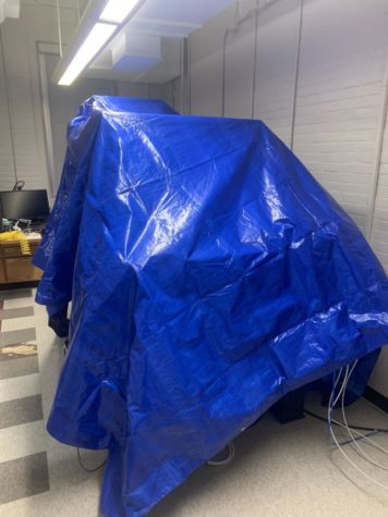 Biology faculty preemptively covered their expensive lab equipment with tarps in case of structural failure.