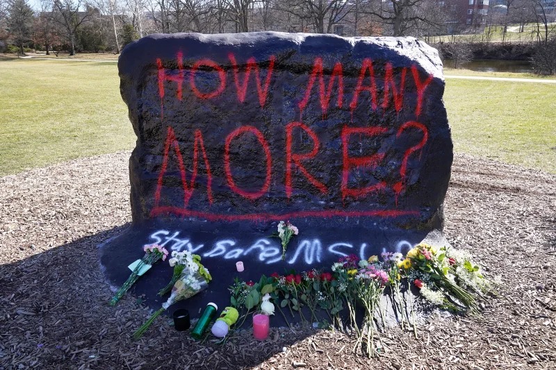The Rock of Michigan State University is painted as a somber memorial to the victims of a mass shooting that left three students dead. 