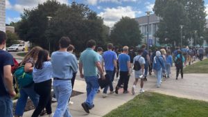 CIM students walk together to Kulas Hall in order to peacefully protest the continued employment of Principal Conductor Carlos Kalmar, wearing blue to symbolize unity.