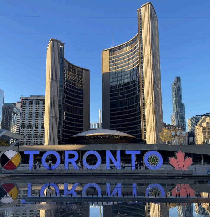 The famous Toronto sign in Nathan Phillips Square highlights the modern and brutalist architecture that the city is known for. 