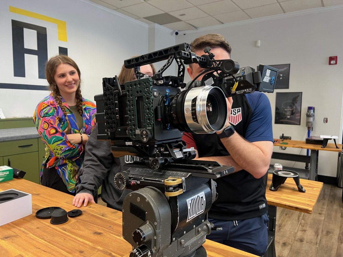 From left to right: Studio 300 members Maizy Windham, Patricia Carrig and Benjamin Nestor visit Liminal Space Productions, an equipment rental warehouse, to check out high-end cameras.