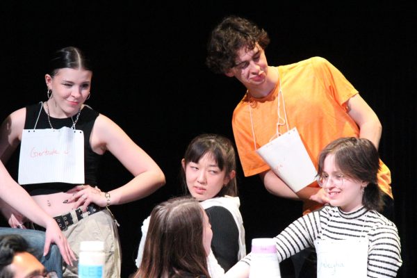 Left to right: Madeline Pollock, Tabitha Raithel, Luke Adelman and Ave Tallarida play a group of sassy cows and Taylor Bruno plays the shop owner at the “Sustainability Sip in the skit “Got Milk?” by Maanyav Gangaraj. 