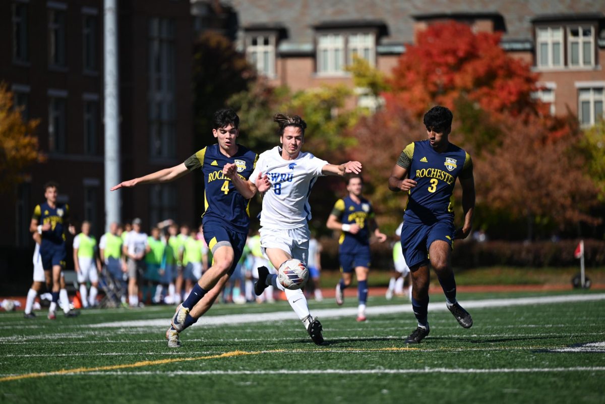 Fourth-year forward Kysen Kroeger maintains possession of the ball against players from Rochester. 