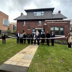 Local officials and community leaders gather in front of the newly opened Wade Park Community Engagement Center for the celebratory ribbon-cutting ceremony.