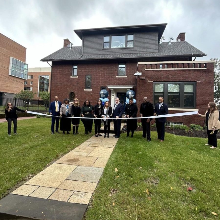 Local officials and community leaders gather in front of the newly opened Wade Park Community Engagement Center for the celebratory ribbon-cutting ceremony.